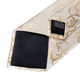 Black and gold patterned tie with brand label on a white background
