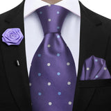Purple polka dot tie with matching pocket square and lapel flower on a suit.