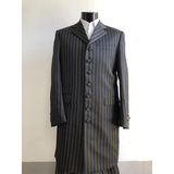 Black mannequin wearing a long, black pinstripe coat with gold lines. The coat has a formal, classic design and button closure, paired with a white shirt.