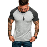 Man wearing a gray and black Raglan sleeve t-shirt on a white background