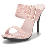 Stylish pinkk high-heeled sandals with a glossy croc-embossed design and a bold gold buckle on a wide strap.