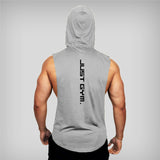 A muscular man in a sleeveless gray hoodie viewed from behind, featuring the text "JUST GYM." vertically along the back.