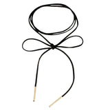 Black suede choker necklace with a bow in the center and gold metal tips at the end. The design is simple and elegant, conveying a chic tone.