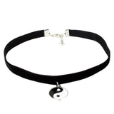 Black velvet choker necklace with a silver Yin-Yang pendant, featuring an adjustable clasp. The design conveys balance and elegance.
