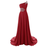 Elegant red one-shoulder evening gown with intricate white floral embellishments on the bodice and waist, featuring a flowing and graceful A-line silhouette.