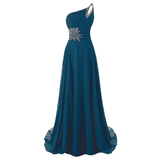 Elegant teal evening gown with one shoulder design, adorned with silver embellishments at the waist and shoulder. Flowing fabric conveys grace.