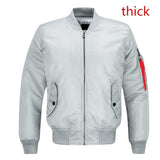 Gray bomber jacket with front zipper and two side pockets, featuring a red zipper detail on the sleeve. The word "thick" appears in red text.