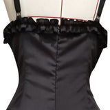 Close-up of a black satin dress with thin straps and a ruffled top edge. The dress has vertical seams and is displayed on a mannequin, suggesting elegance.