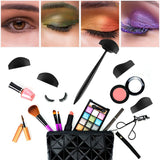 A collage showing different eyeshadow styles in green, orange, and purple above a variety of makeup items including brushes, lipstick, and a black bag.